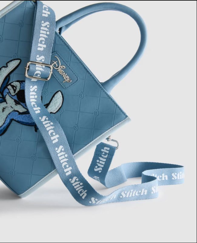 Blue bag with strap featuring 'Stitch' branding on a light gray background