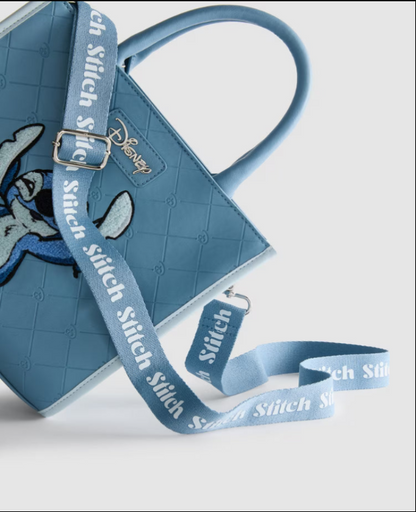 Blue bag with strap featuring 'Stitch' branding on a light gray background