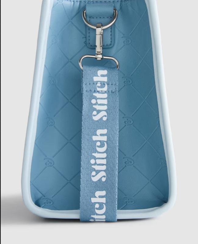 Blue quilted bag with a matching strap featuring 'Sewich Stitch' branding on a light gray background.