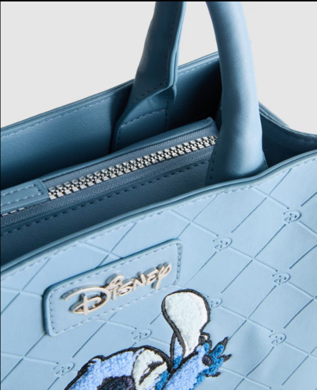 Blue handbag with Disney logo and character design on a light gray background