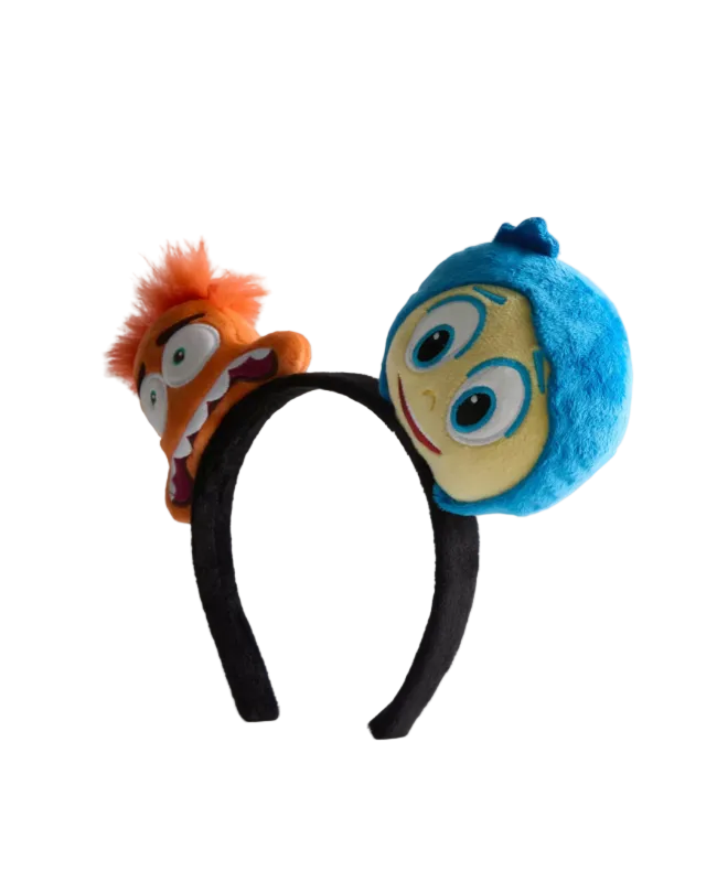 Plush headband with cartoon character faces on a white background