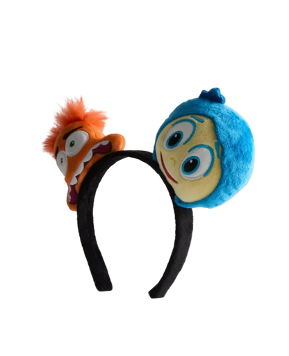 Plush headband with cartoon character faces on a white background
