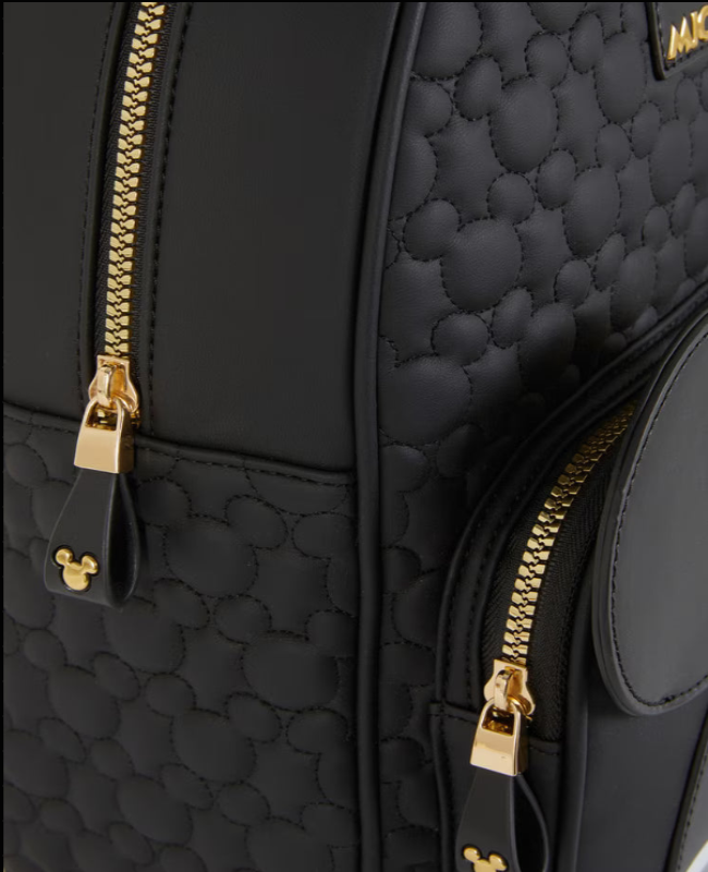 Black quilted backpack with gold zippers and Mickey Mouse head design.