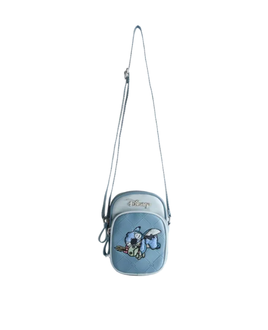 Blue crossbody bag with a character design on a light gray background