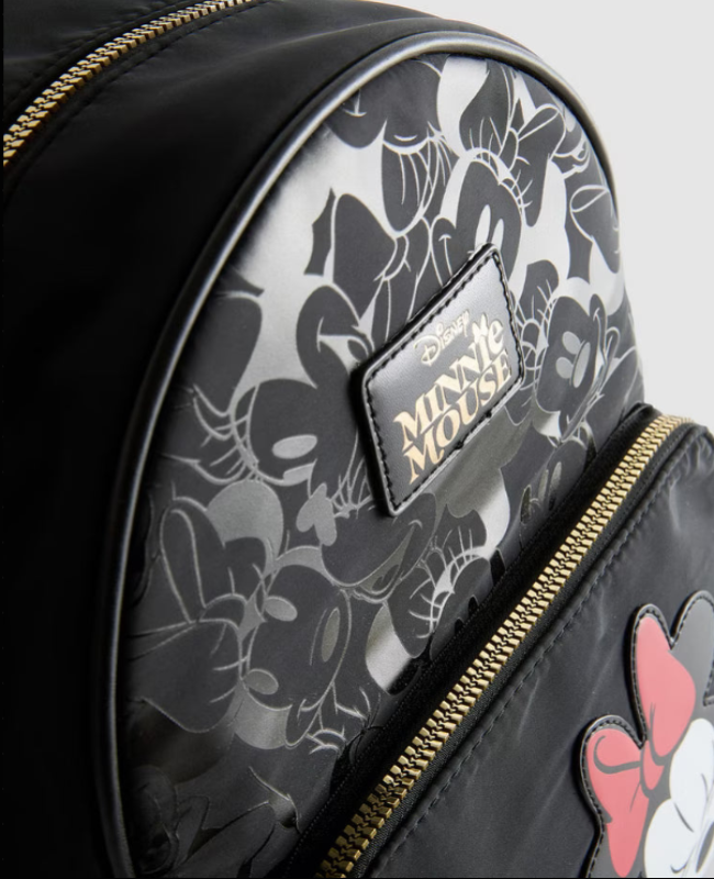 Black backpack with Minnie Mouse floral pattern and logo on a gray background