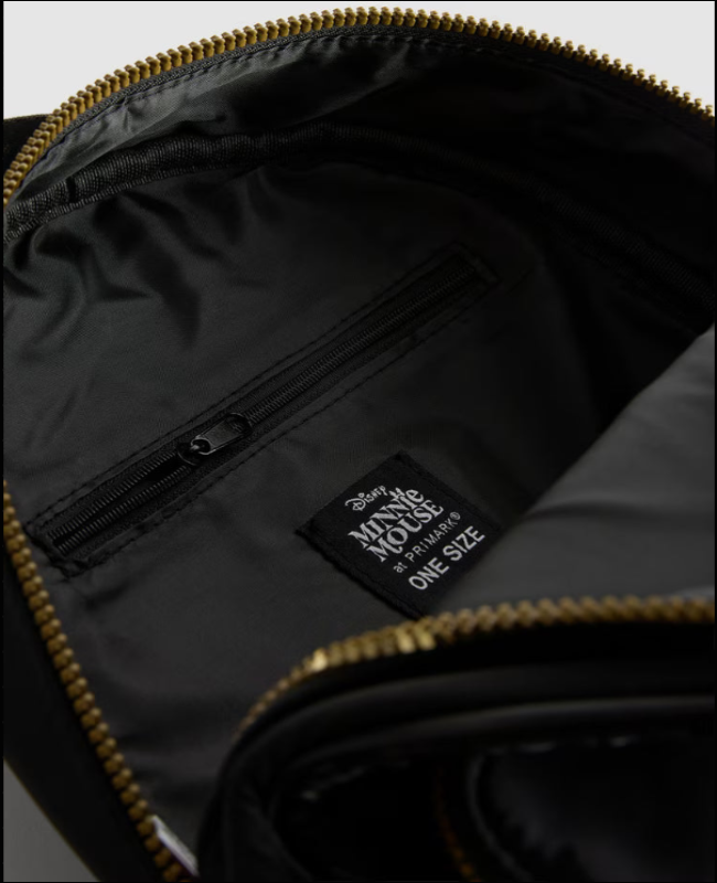 Black bag with gold zipper and Minnie Mouse label on a gray background