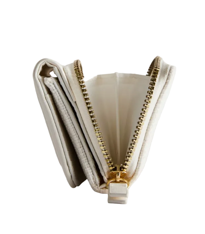 Open beige clutch with gold zipper on a light gray background