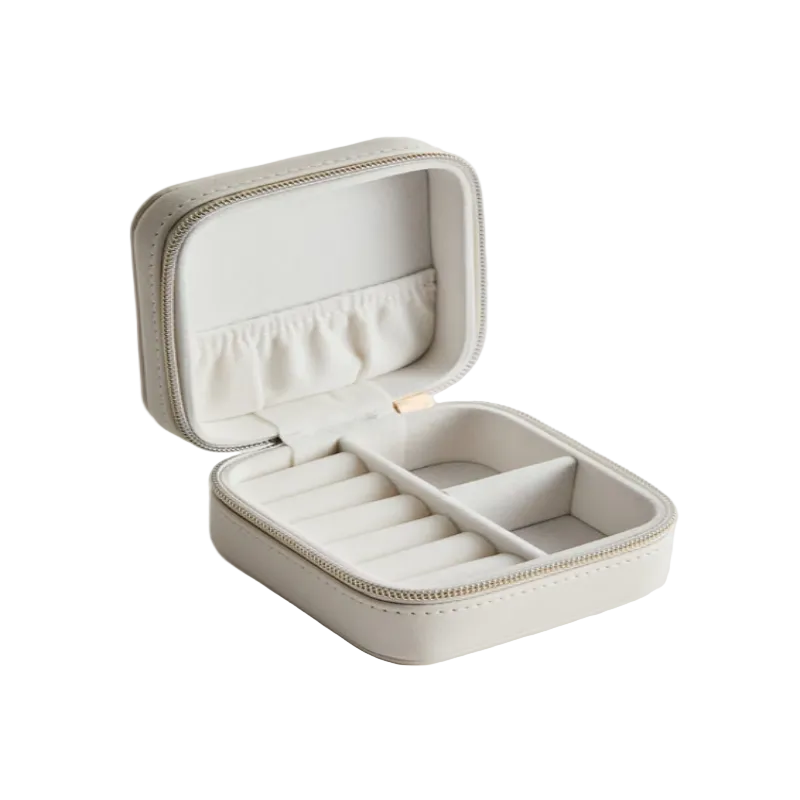 Beige jewelry box with compartments on a light gray background