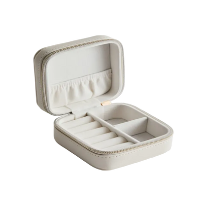 Beige jewelry box with compartments on a light gray background