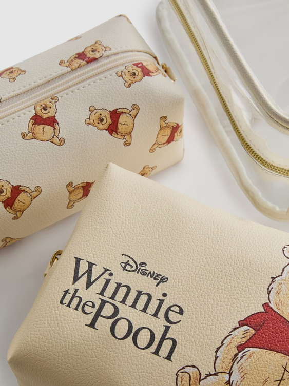 Winnie the Pooh-themed pouches with character illustrations on a light background