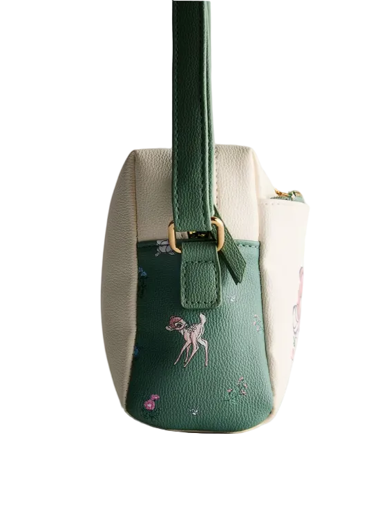 Small handbag with green top section and beige bottom section on a light gray background
