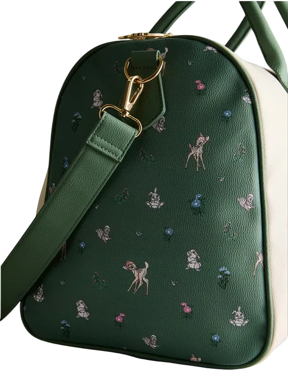Green handbag with embroidered designs on a light gray background