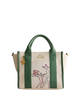 Handbag with green straps and a character design on a light gray background