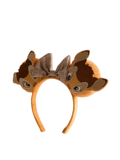 Brown animal-themed headband with ears and bow on a light gray background