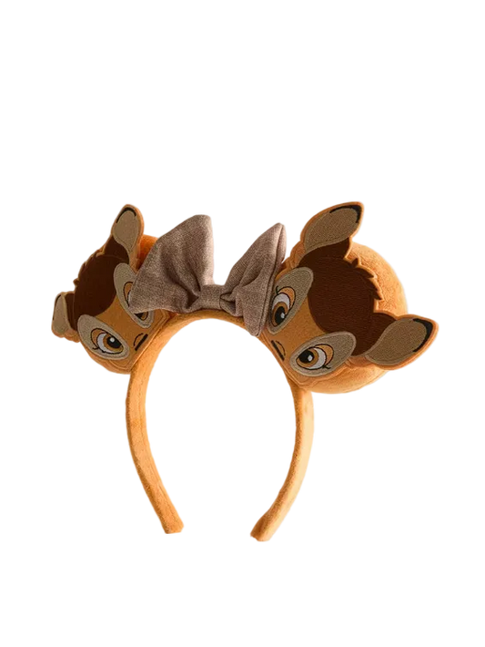 Brown animal-themed headband with ears and bow on a light gray background