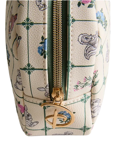 Patterned pouch with a gold zipper on a light gray background