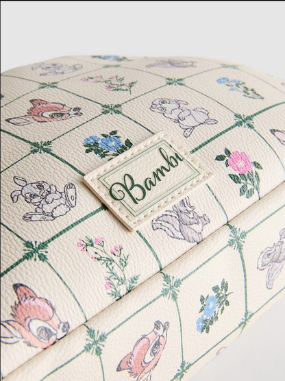 Product with 'Bambi' branding featuring cartoon characters and floral patterns on a checkered background.