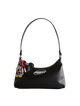 Black handbag with a Mickey Mouse charm on a light gray background