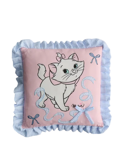 Decorative pillow with a cartoon cat design on a light pink background
