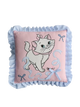 Decorative pillow with a cartoon cat design on a light pink background