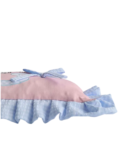Pink and blue pillow with ruffled edge on a light gray background