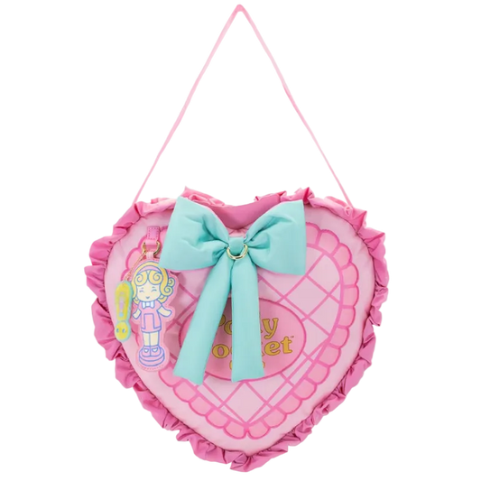 Heart-shaped pink pillow with a blue bow and toy figure on a white background