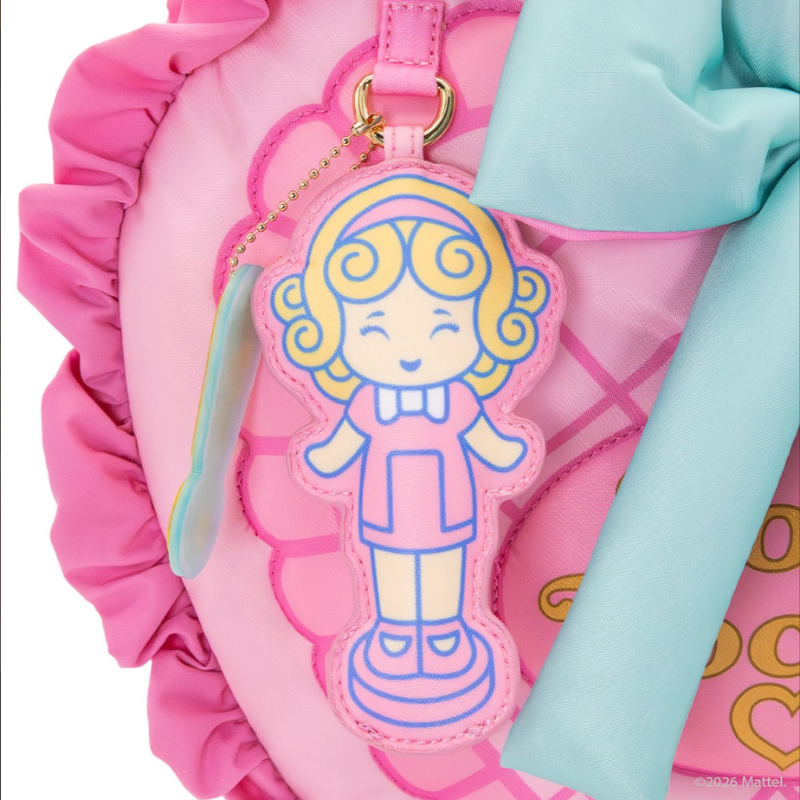 Pink bag with a cartoon character keychain on a white background