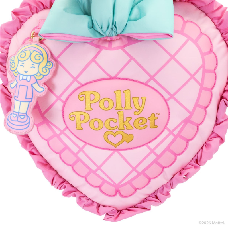 Heart-shaped pillow with 'Polly Pocket' branding and a character figure on a white background
