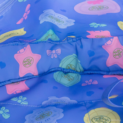 Blue inflatable pool float with colorful starfish and butterfly designs on a blue background.