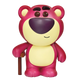 Toy figure of a pink and yellow bear with a purple nose on a white background