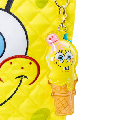 Keychain with a cartoon character in an ice cream cone shape attached to a yellow bag.