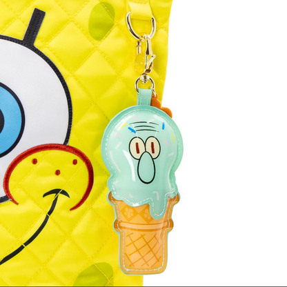 Ice cream cone-shaped keychain with cartoon face on a yellow background