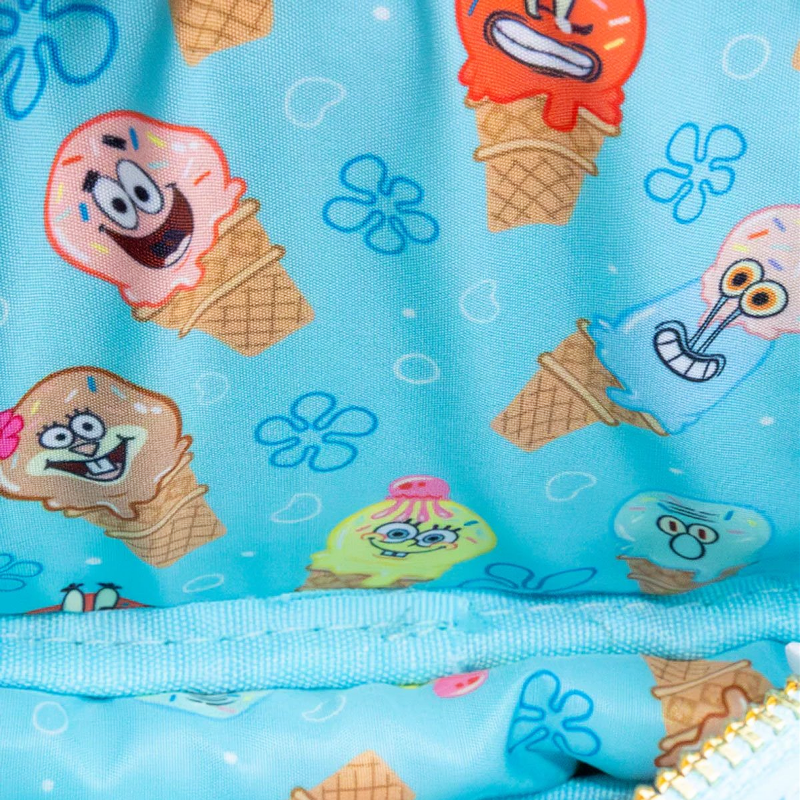 Close-up of a blue fabric with cartoon ice cream cones and characters on a light blue background.