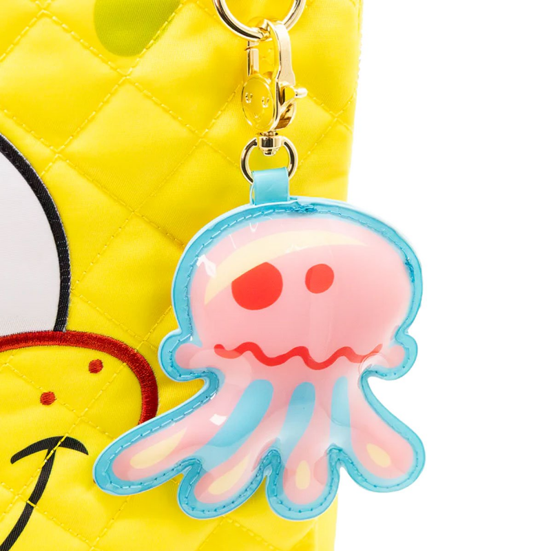 Pink jellyfish keychain on a yellow background