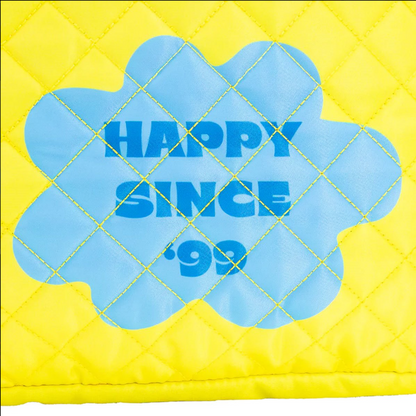 Yellow quilted pillow with blue floral design and 'Happy Since '99' text