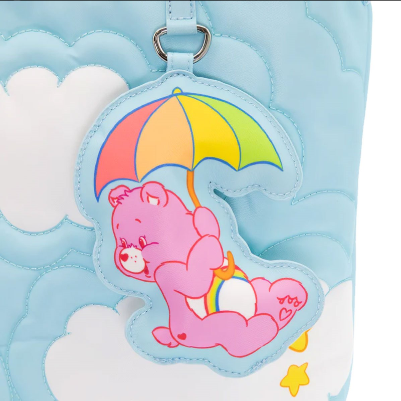 Pink bear with an umbrella keychain on a blue textured background