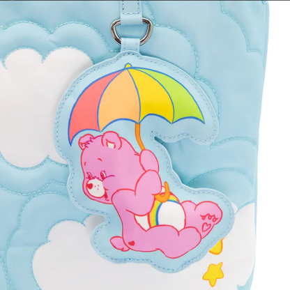 Pink bear with an umbrella keychain on a blue textured background