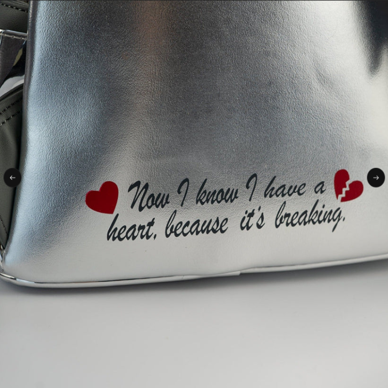 Silver bag with a humorous quote about a heartbreak on a plain background