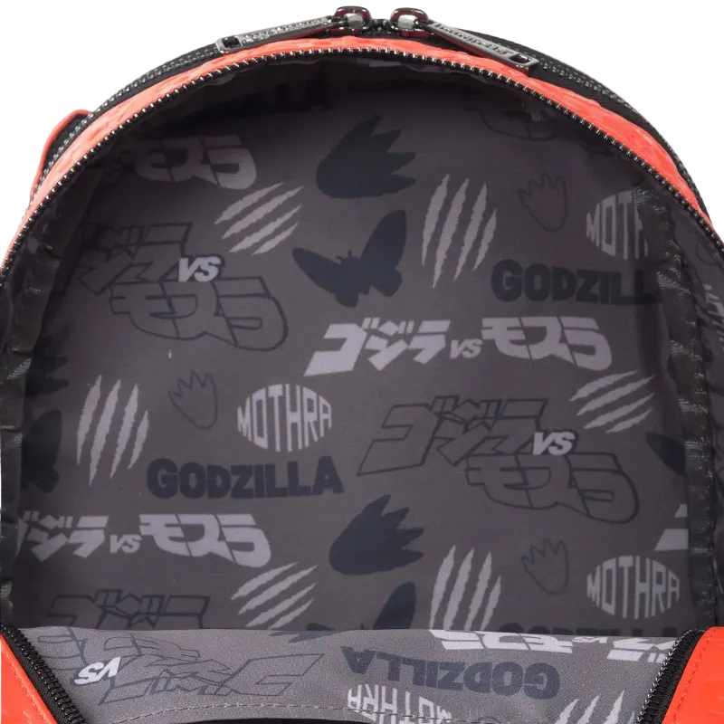 Backpack interior with Godzilla vs Mothra pattern on a gray background