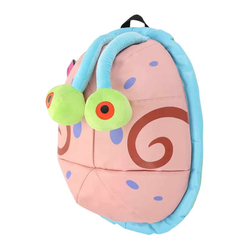 Plush toy resembling a cartoon character with a pink body, blue headband, and green eyes on a white background.