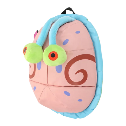 Plush toy resembling a cartoon character with a pink body, blue headband, and green eyes on a white background.