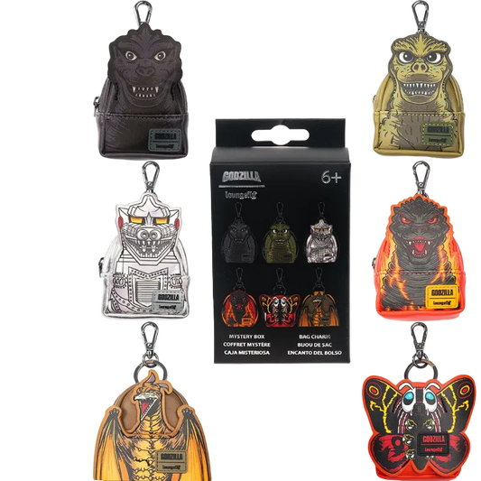 Collection of Godzilla-themed keychains with packaging in the center.