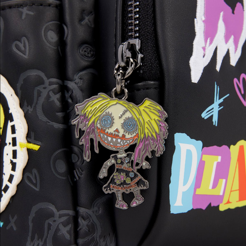 Keychain with a colorful character on a black bag with graphics and text.