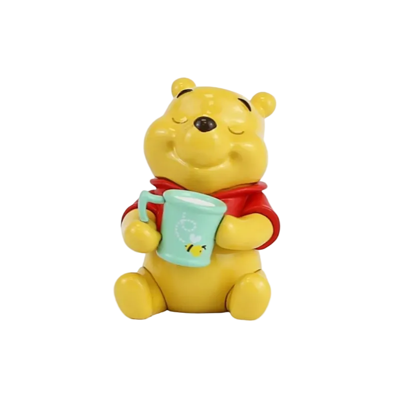 Yellow bear character holding a green mug with a straw on a white background