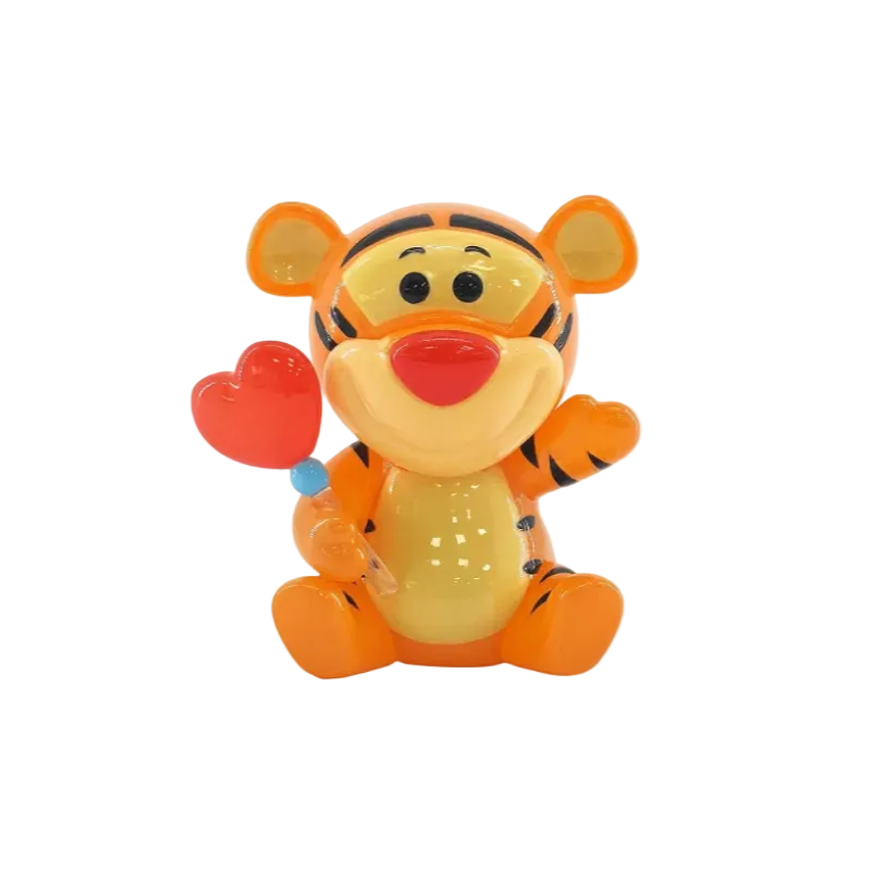 Toy figure of a tiger holding a heart on a white background