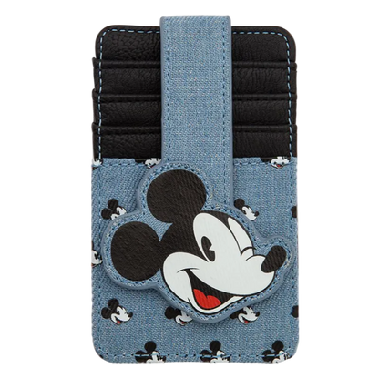 A Disney Mickey Mouse card holder wallet in a light blue denim-like material with black and white Mickey pattern, featuring a large Mickey head patch on the front and a black card slot compartment.