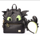 Black faux-snakeskin Toothless dragon backpack with bright lime green eyes, gold zipper, and matching black-and-lime headband on a white background.