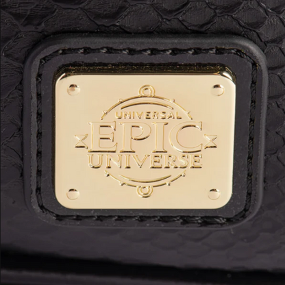 Close-up of a black textured leather strap with a square gold-tone metal plaque engraved with the words 'UNIVERSAL EPIC UNIVERSE'.