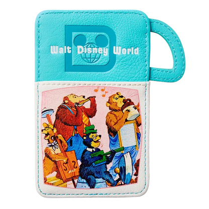 A turquoise and white faux leather luggage tag featuring the Walt Disney World logo and a colorful cartoon illustration of park characters playing instruments on the front pocket.