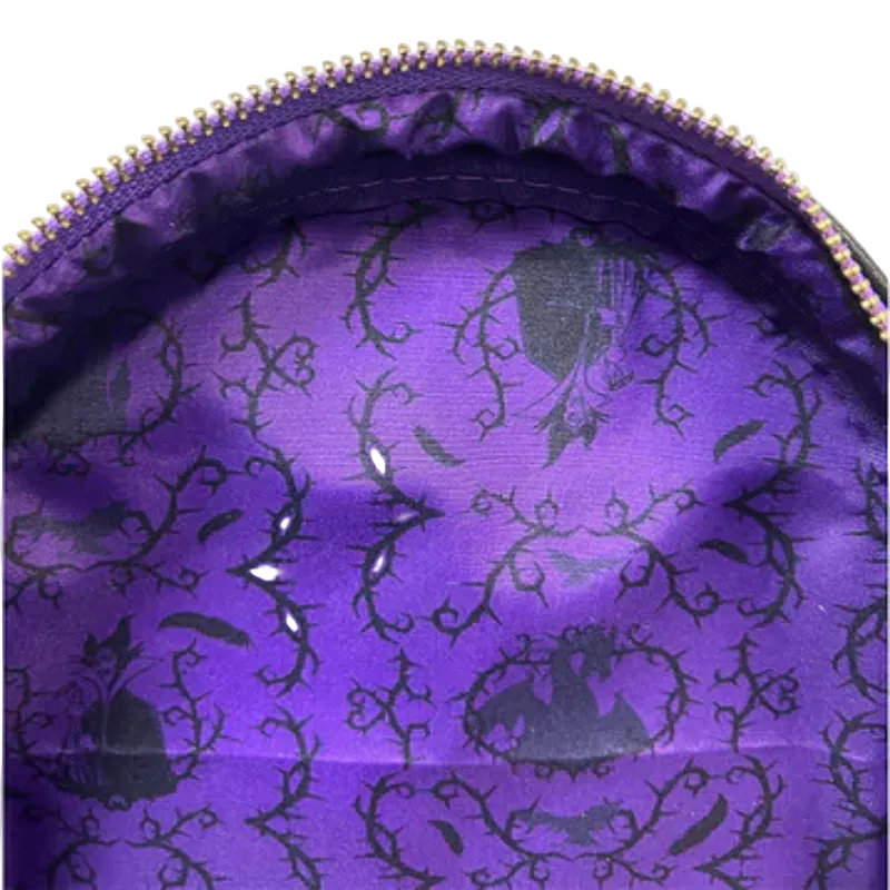 Close-up of a purple fabric with black floral patterns inside a zipper pouch.